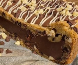 Chocolate chip cookie dough filled with rich chocolate and topped with white chocolate drizzle.