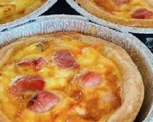 Savory pastry tarts filled with cheese, ham, and egg.